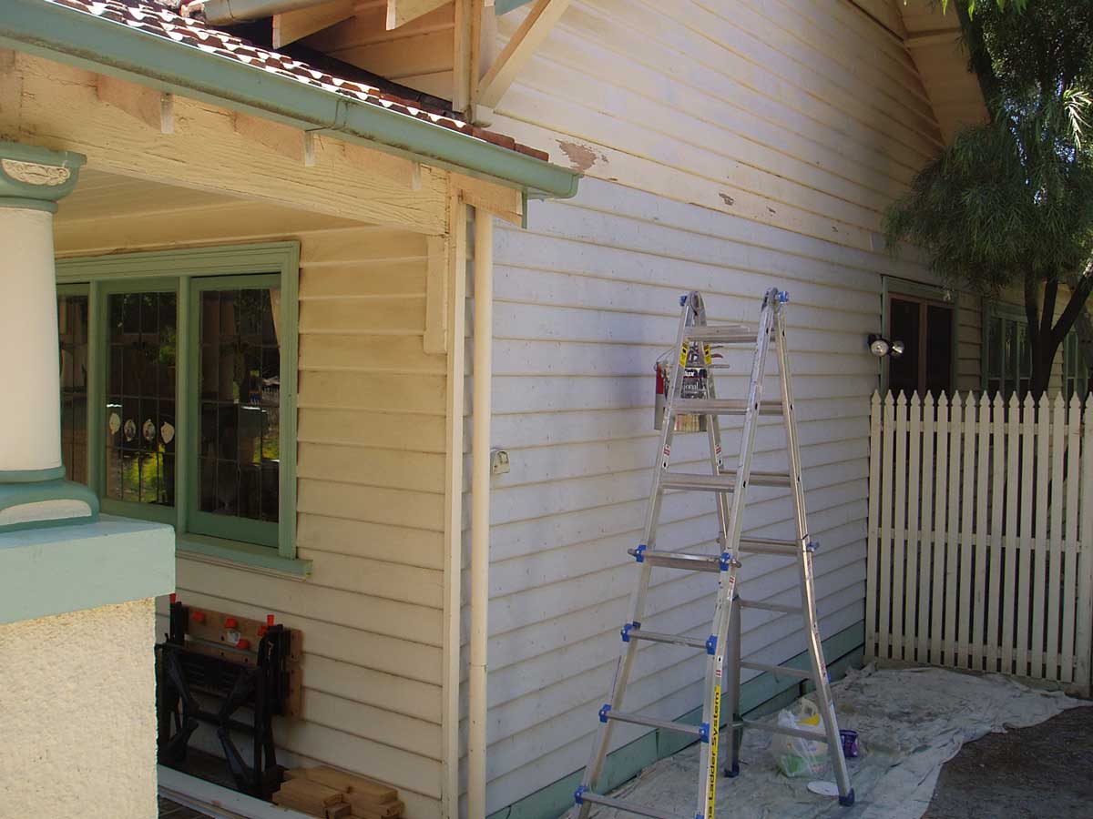 Weatherboard house side wall mid-prep, ladder and drop sheet