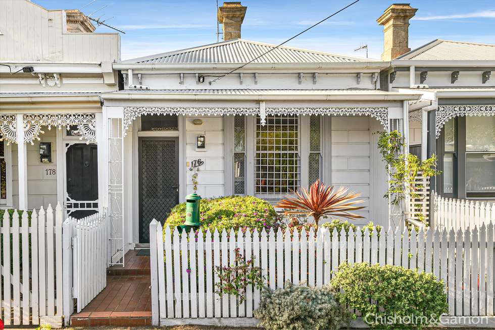 Victorian white terrace house with lace ironwork and picket fence